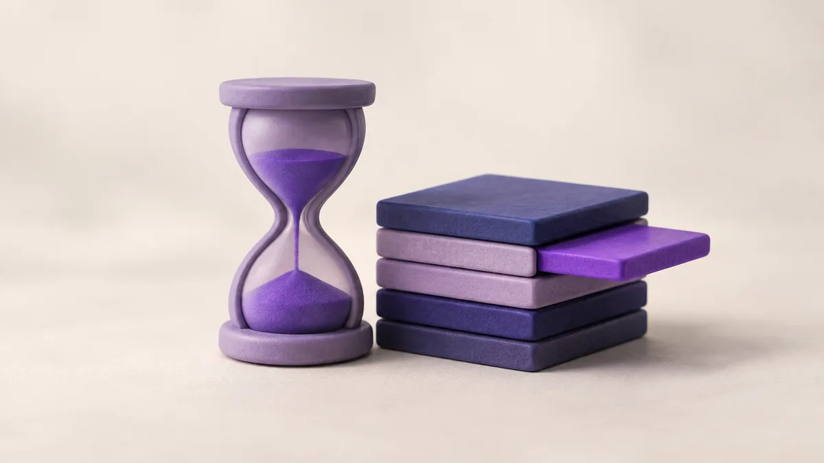 A small clay hourglass beside a stack of flat clay tiles, one tile slid halfway out as if being put back