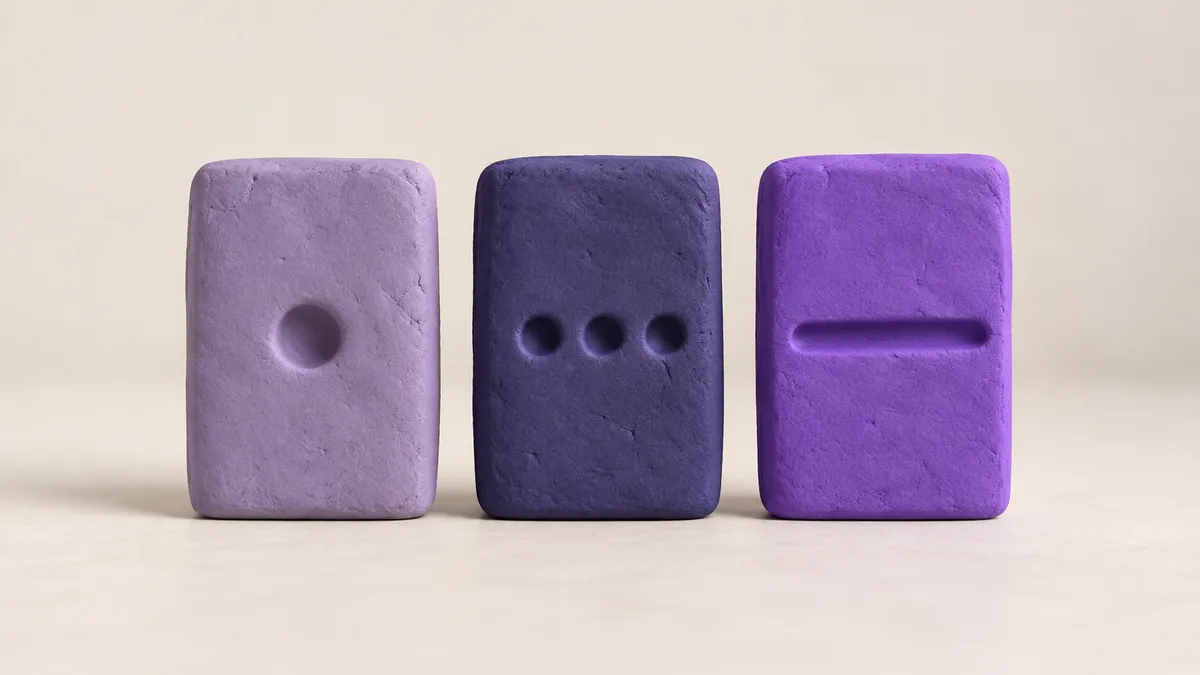 Three upright clay tablets side by side: one with a single round notch, one with three small dimples, one with a long shallow groove, like three kinds of question